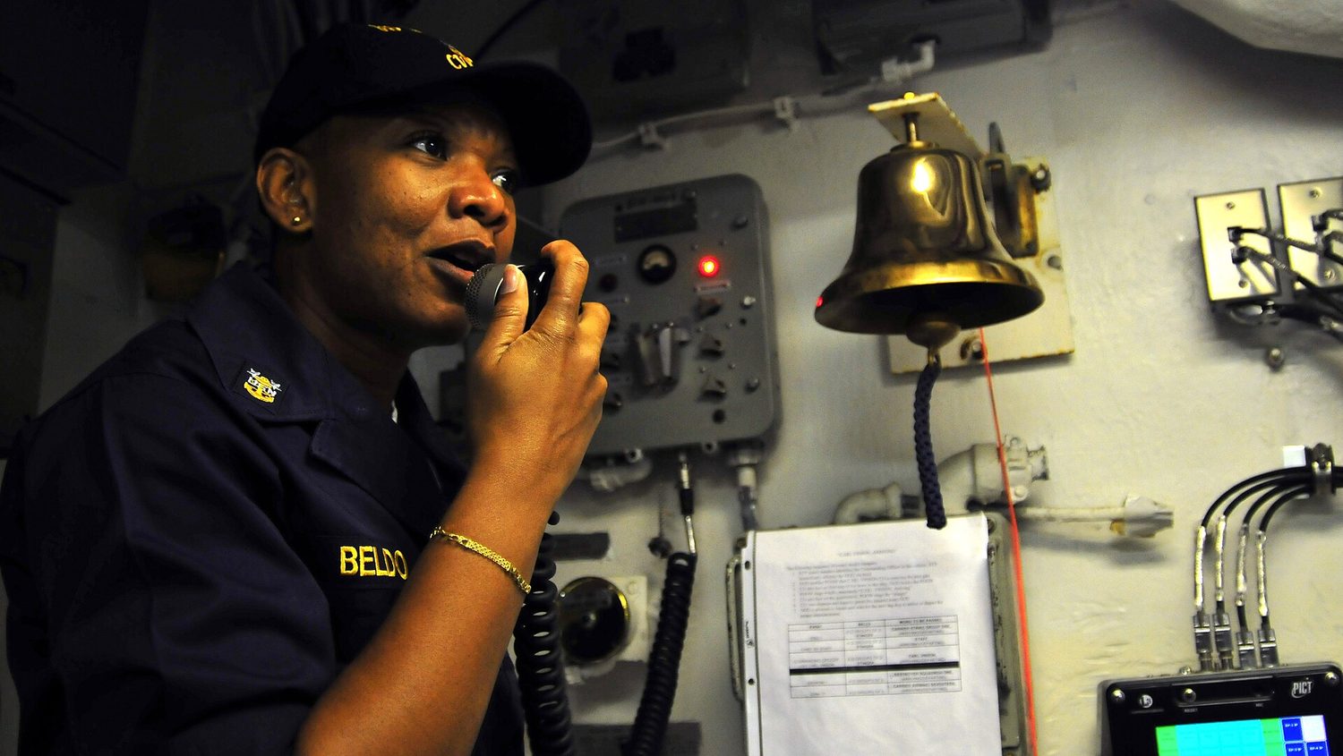 Command Master Chief April Beldo speaks on the 1MC aboard USS Carl Vinson.