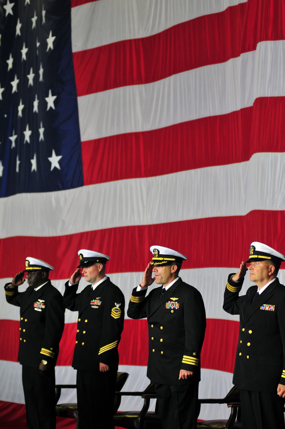 Sailors render honors during the national anthem aboard USS Carl Vinson.